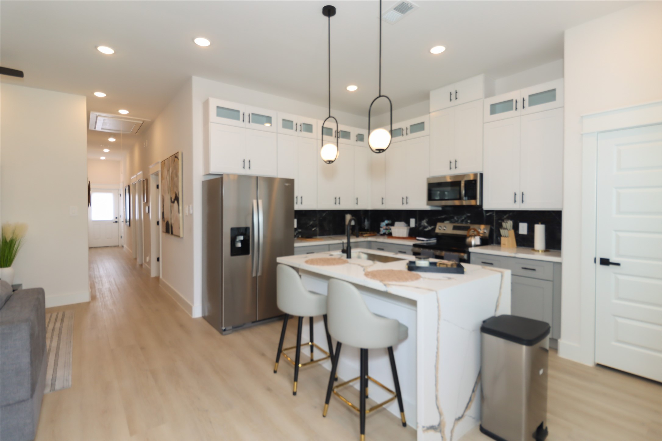 4902 Higgins Street, Unit B Houston, TX 77033 - Photo 10 of 39 a kitchen with stainless steel appliances kitchen island a refrigerator and a stove top oven