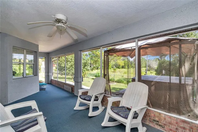 a dining room with furniture water view and a floor to ceiling window