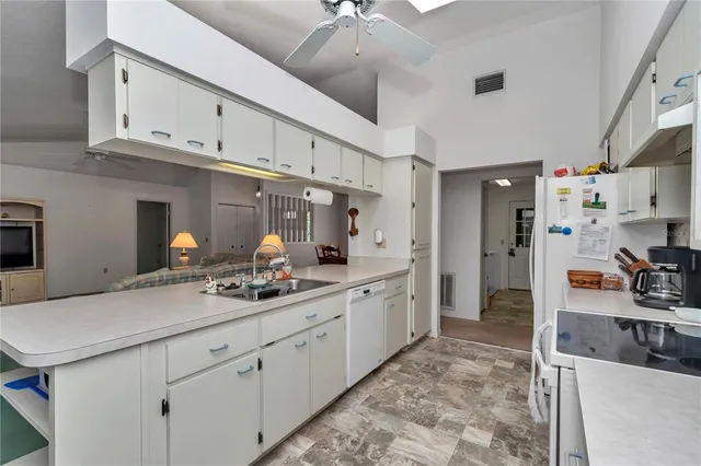 a kitchen with cabinets a sink and appliances
