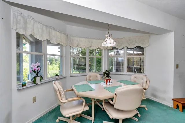 a dining room with furniture a chandelier and window