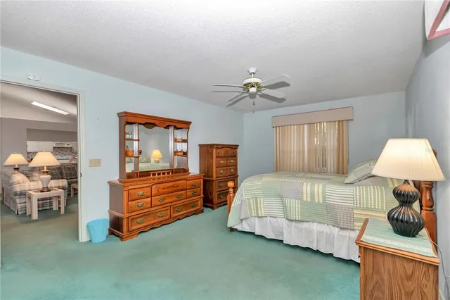 a bedroom with a bed and a chair