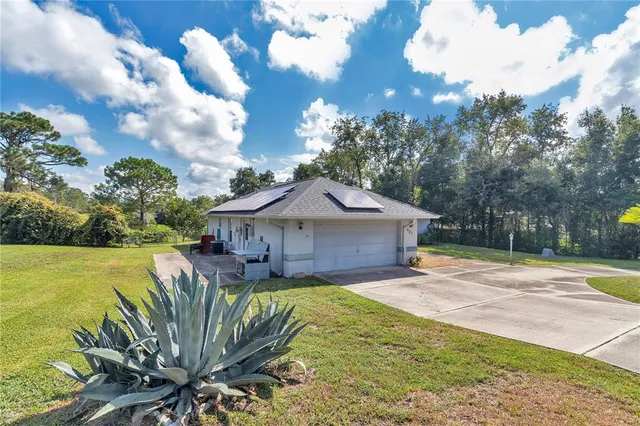 a yellow house with trees in front of it