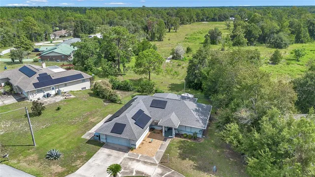 an aerial view of a house with a yard