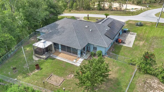 an aerial view of a house with a garden