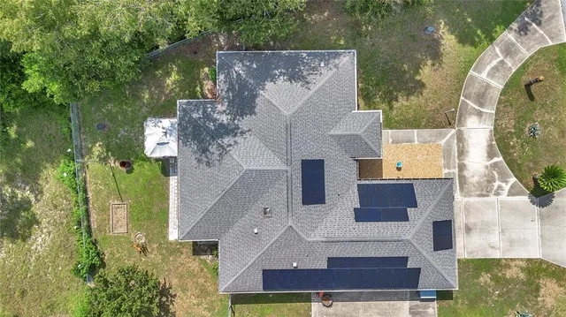 an aerial view of a house with a swimming pool