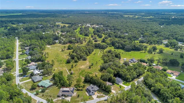 an aerial view of a houses with a yard