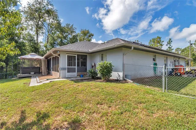 a view of a house with a yard patio and fire pit
