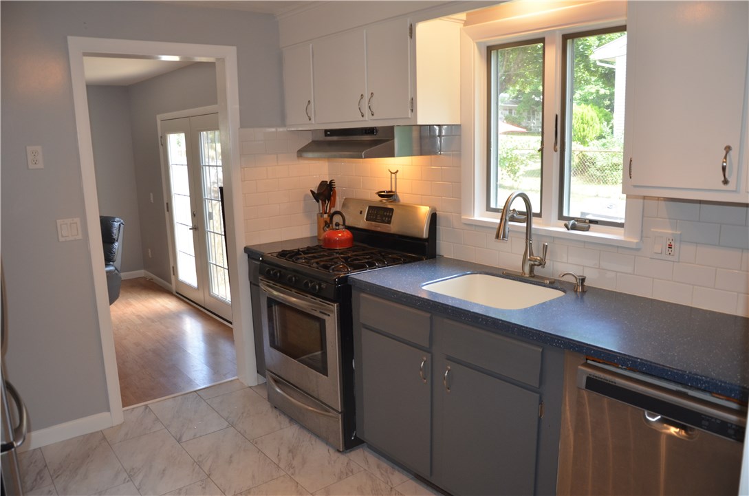 17 Jade Road Coventry, RI 02816 - Photo 5 of 46 The kitchen cabinetry has been painted with lighter uppers and a darker lower and the hardware has been updated with attractive brushed nickle hardware