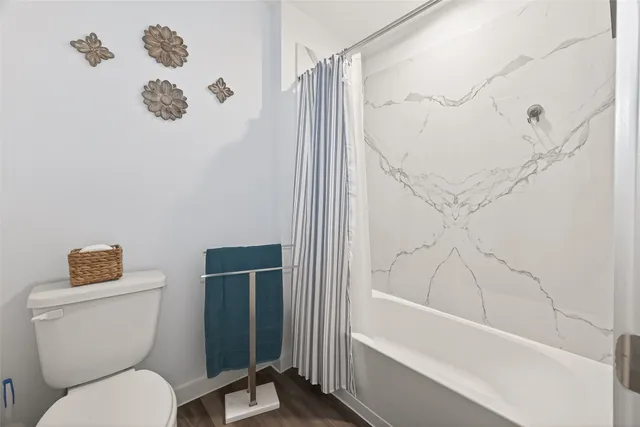 a bathroom with a toilet and a shower