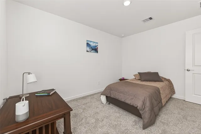 a bedroom with a bed and a dresser