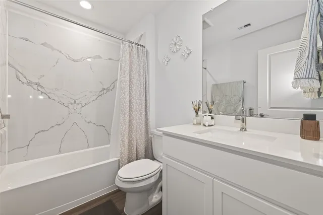 a bathroom with a sink toilet and mirror