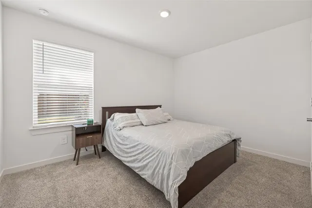 a bedroom with a bed and a mirror