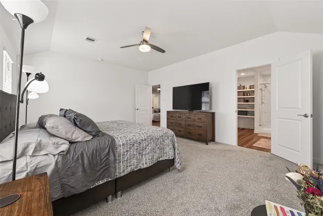 a bedroom with a bed dresser and a window