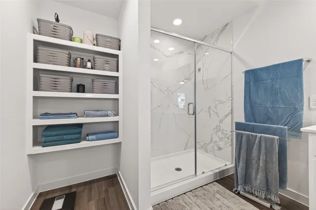 a view of walk in closet with clothes and shoes