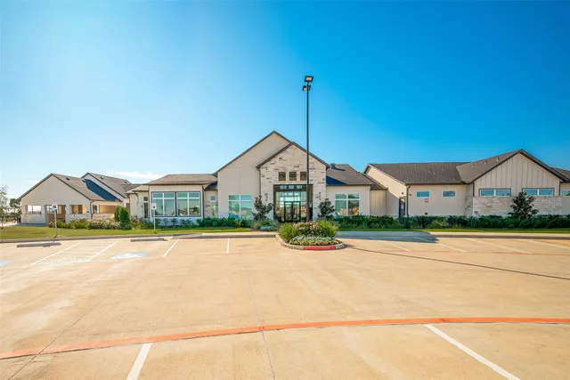 a view of a house with swimming pool and sitting area