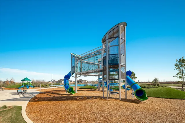 a outdoor space with lots of tables a large window and chairs
