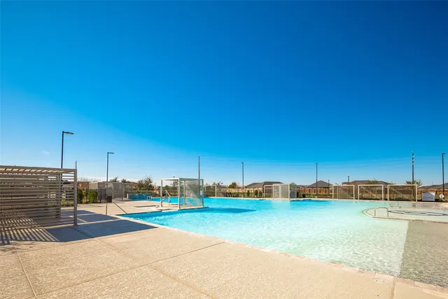 a view of a swimming pool with a lawn chairs