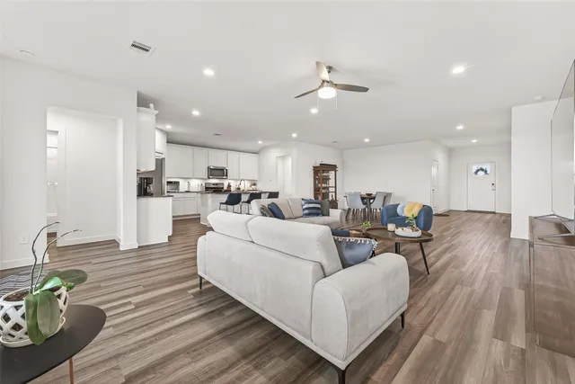 a living room with furniture and kitchen view
