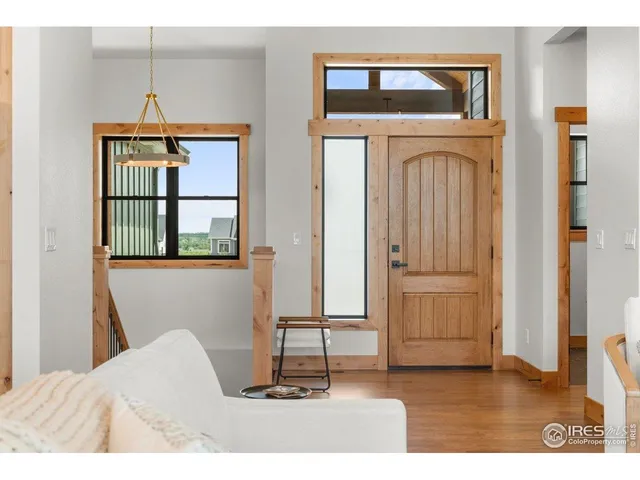 a living room with a fireplace windows and a wooden floor