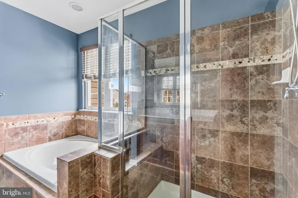 a bathroom with a tub and shower