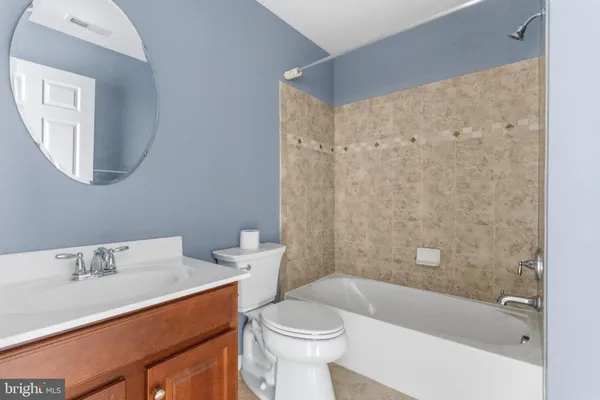 a bathroom with a sink a toilet and a bathtub