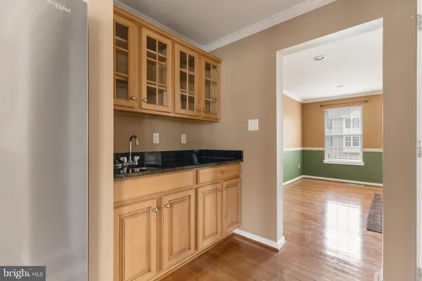 a view of a house with wooden floor and a kitchen