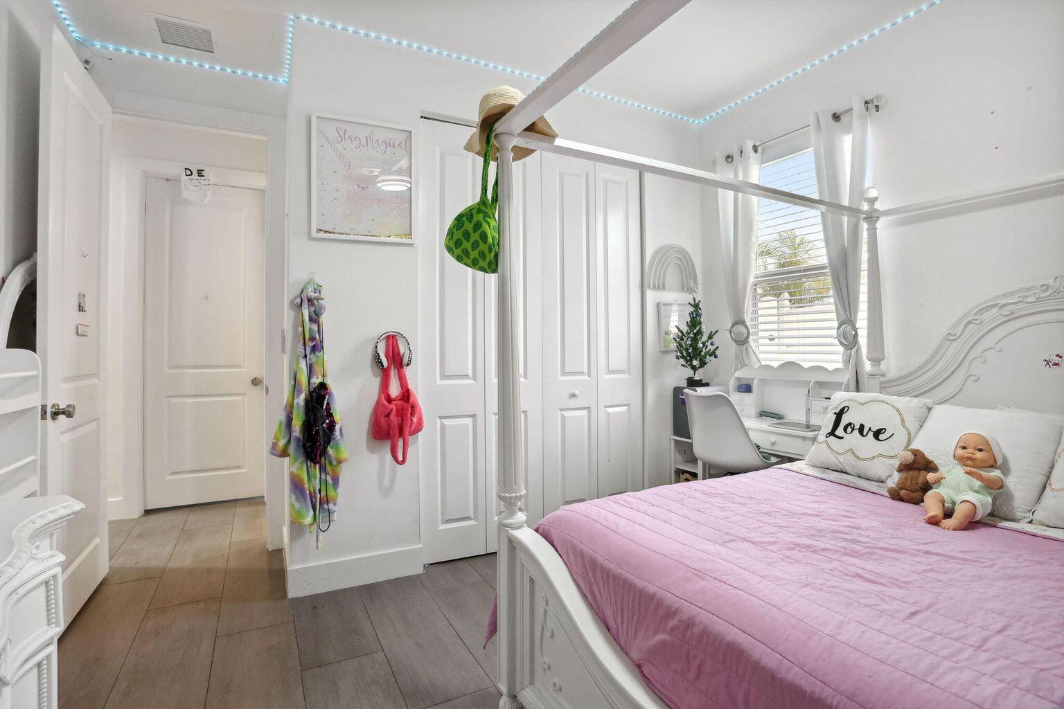 6944 2nd Street Jupiter, FL 33458 - Photo 14 of 26 a bedroom with a bed and a window