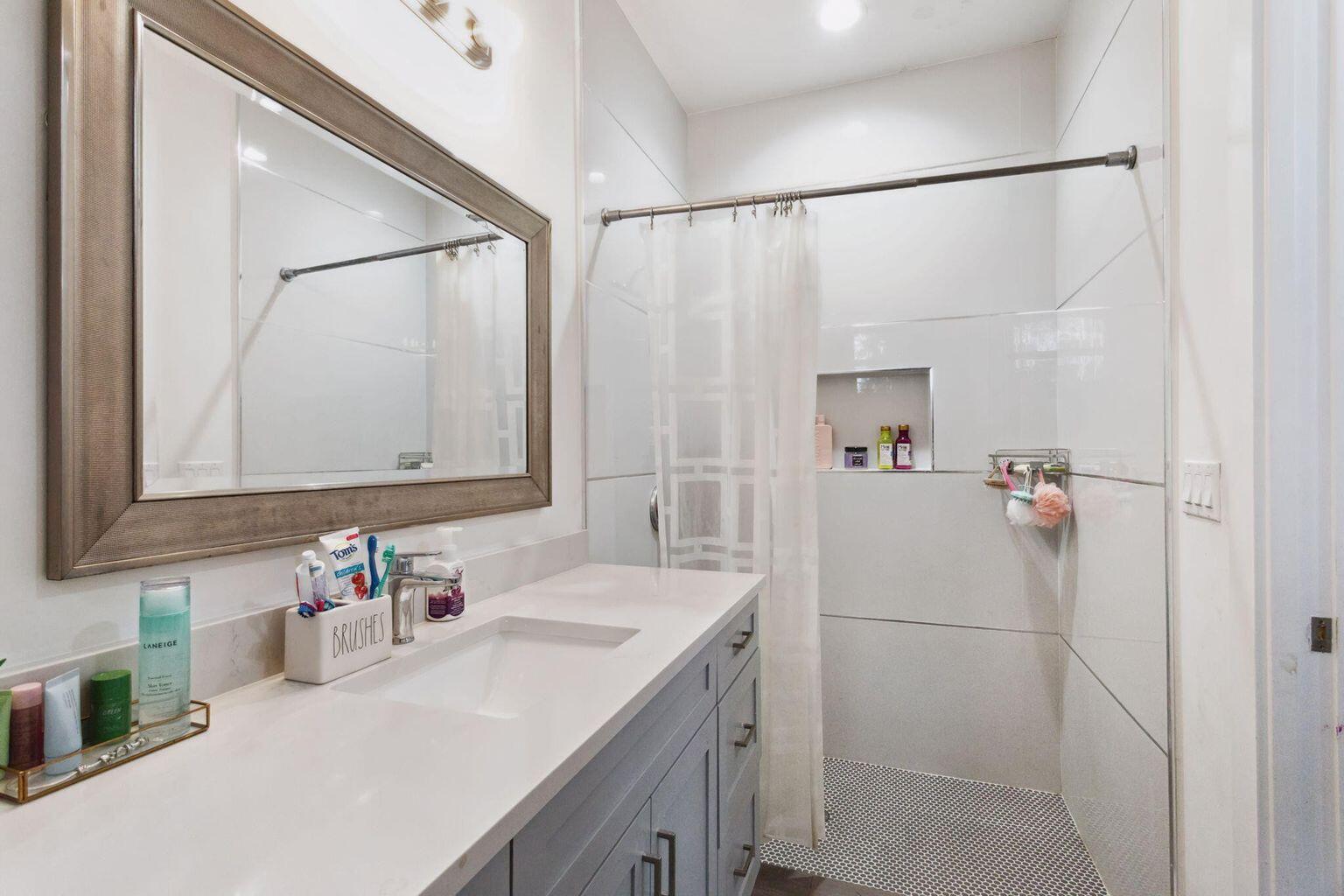 6944 2nd Street Jupiter, FL 33458 - Photo 16 of 26 a bathroom with a sink and a mirror