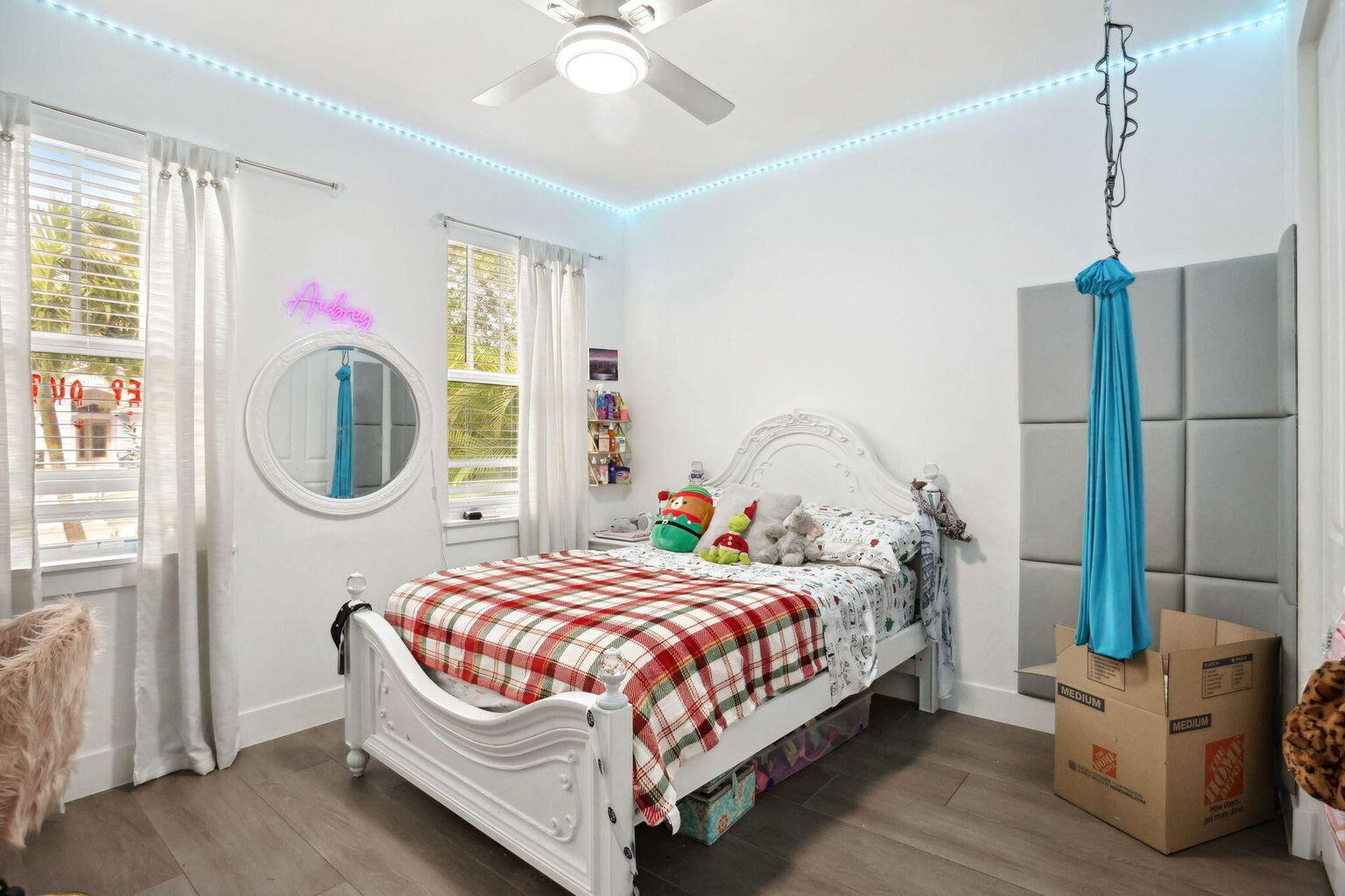 6944 2nd Street Jupiter, FL 33458 - Photo 17 of 26 a bedroom with a bed table closet and a window