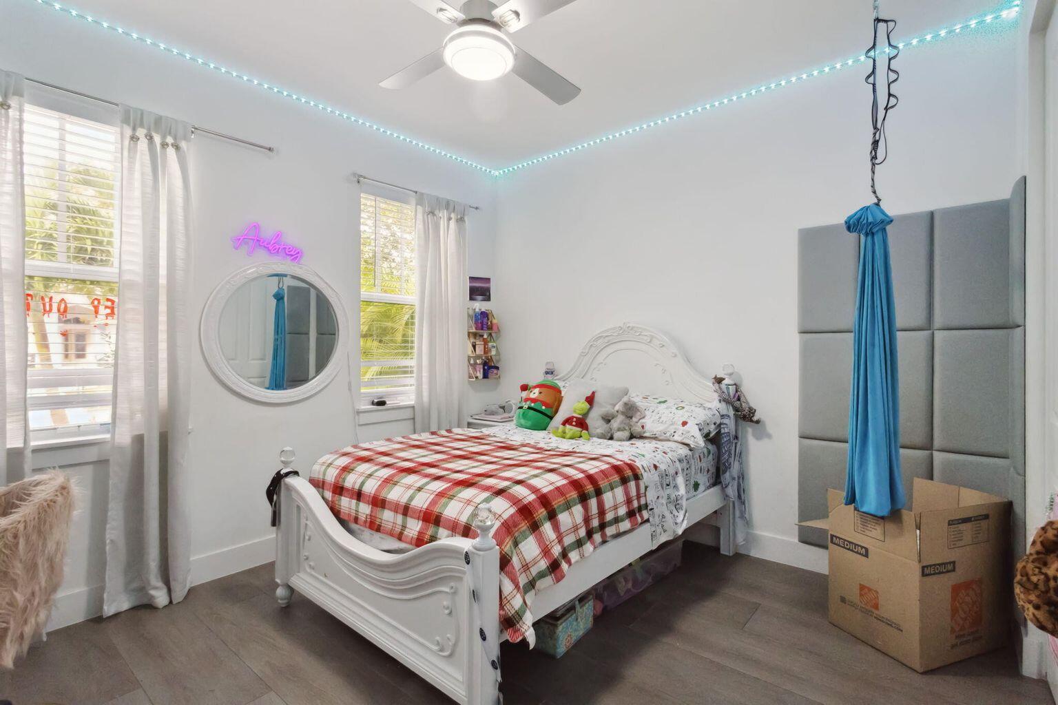 6944 2nd Street Jupiter, FL 33458 - Photo 18 of 26 a bedroom with a bed a window and dresser