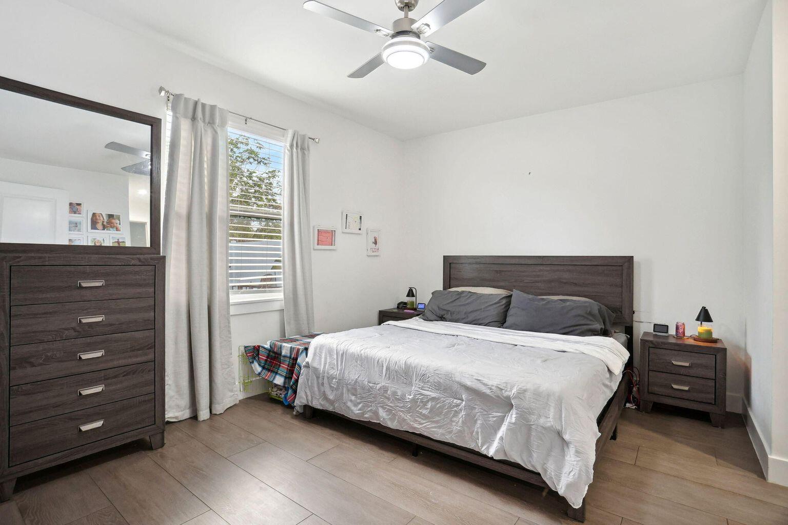 6944 2nd Street Jupiter, FL 33458 - Photo 10 of 26 a bedroom with a bed and a dresser