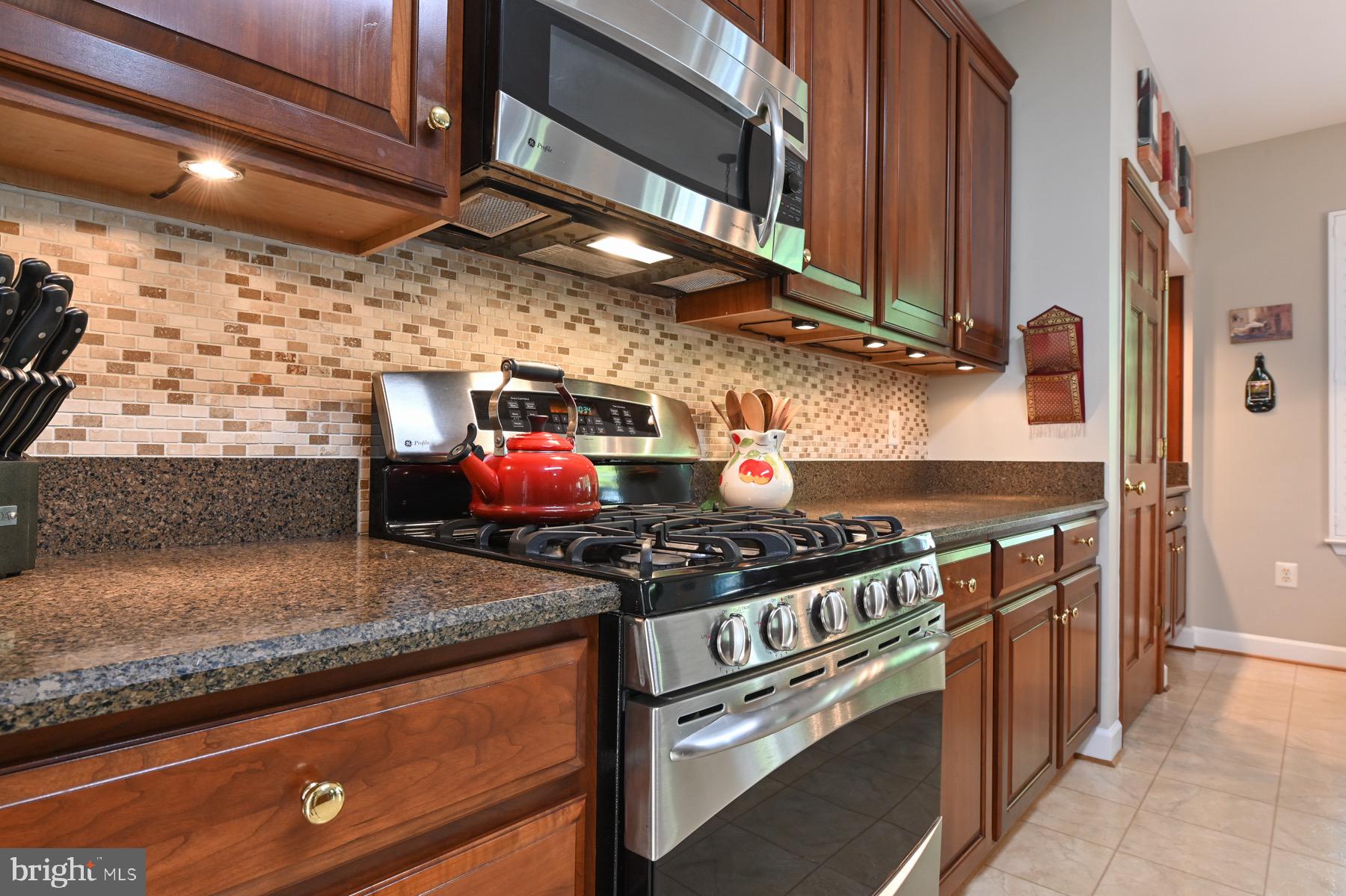 11206 Poplar Grove Court Laurel, MD 20708 - Photo 15 of 67 a kitchen with stainless steel appliances granite countertop a stove and a sink