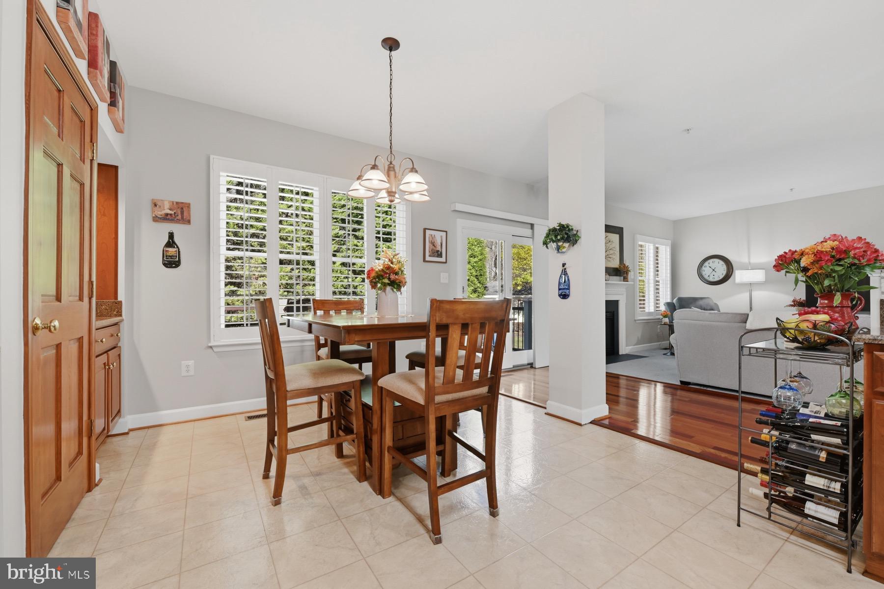 11206 Poplar Grove Court Laurel, MD 20708 - Photo 18 of 67 a view of a dining room and livingroom with furniture wooden floor a chandelier