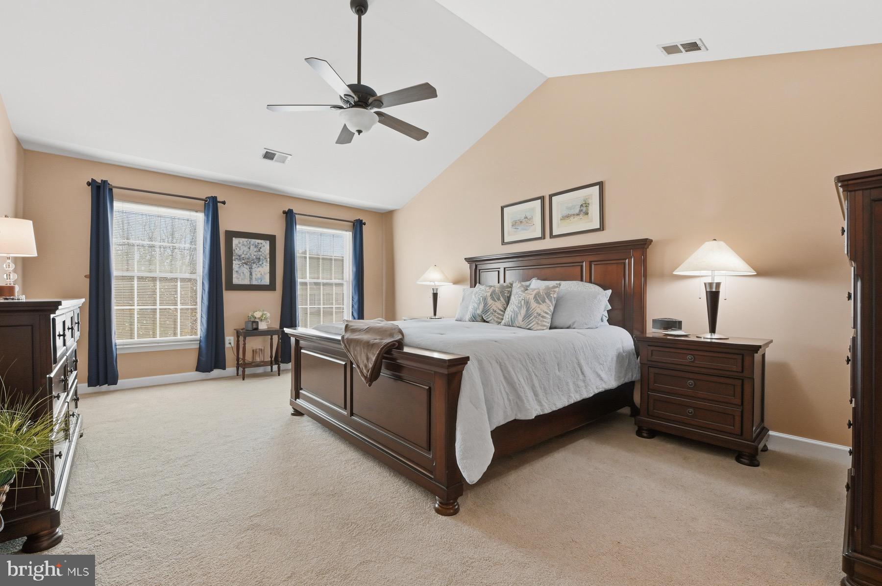 11206 Poplar Grove Court Laurel, MD 20708 - Photo 23 of 67 a spacious bedroom with a bed and a flat screen tv