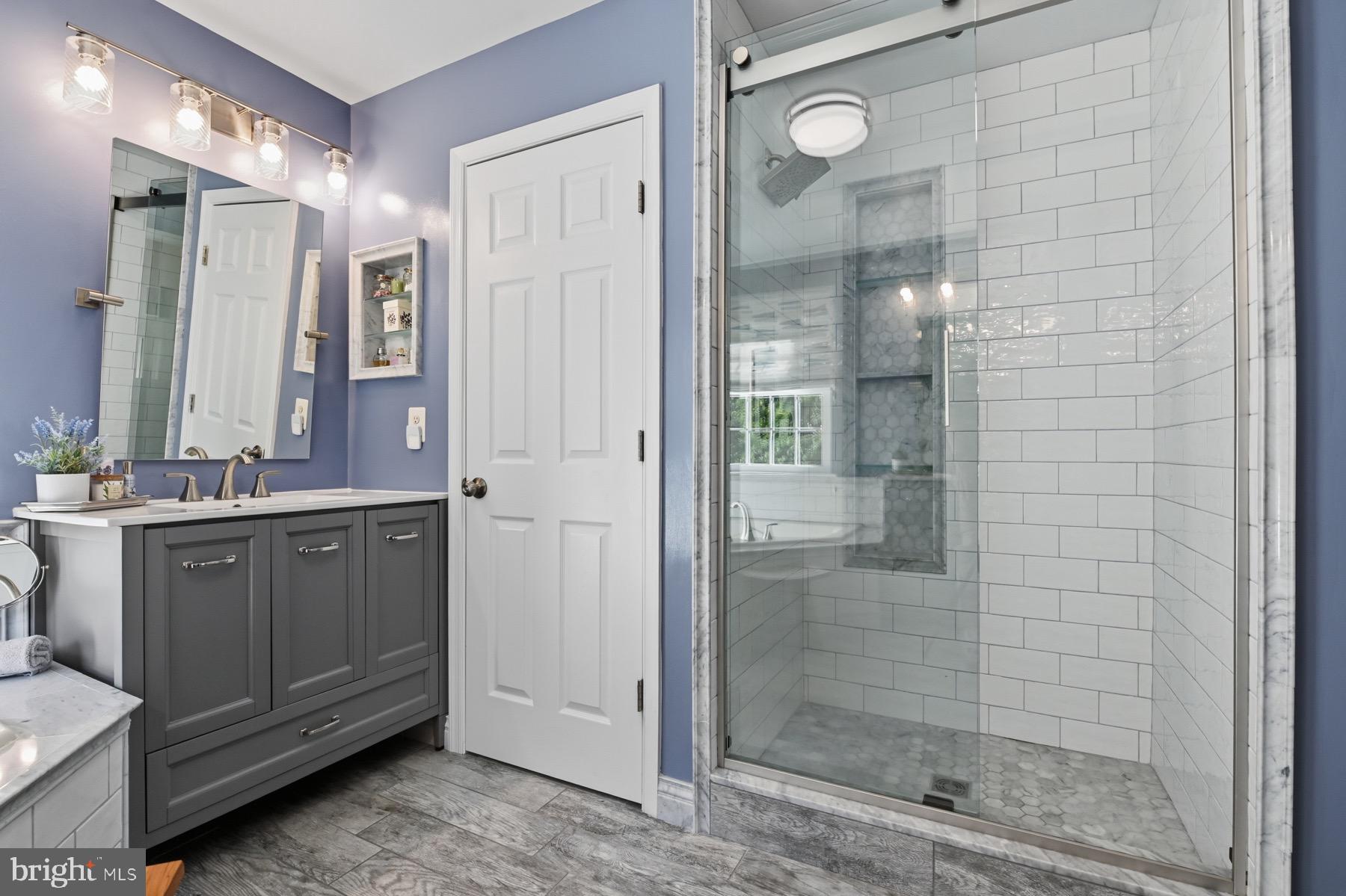11206 Poplar Grove Court Laurel, MD 20708 - Photo 24 of 67 a bathroom with a shower sink and mirror