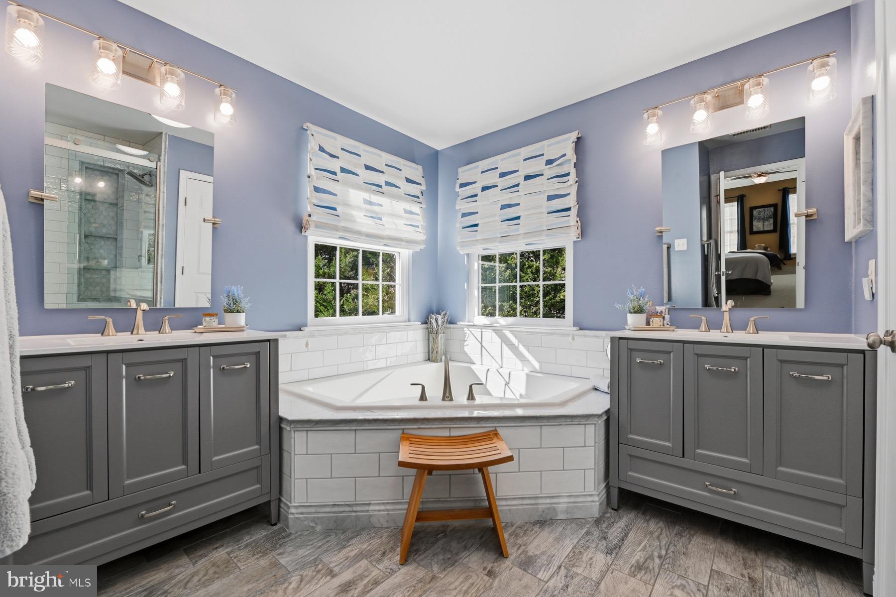 11206 Poplar Grove Court Laurel, MD 20708 - Photo 25 of 67 a bathroom with a sink a vanity and a large mirror
