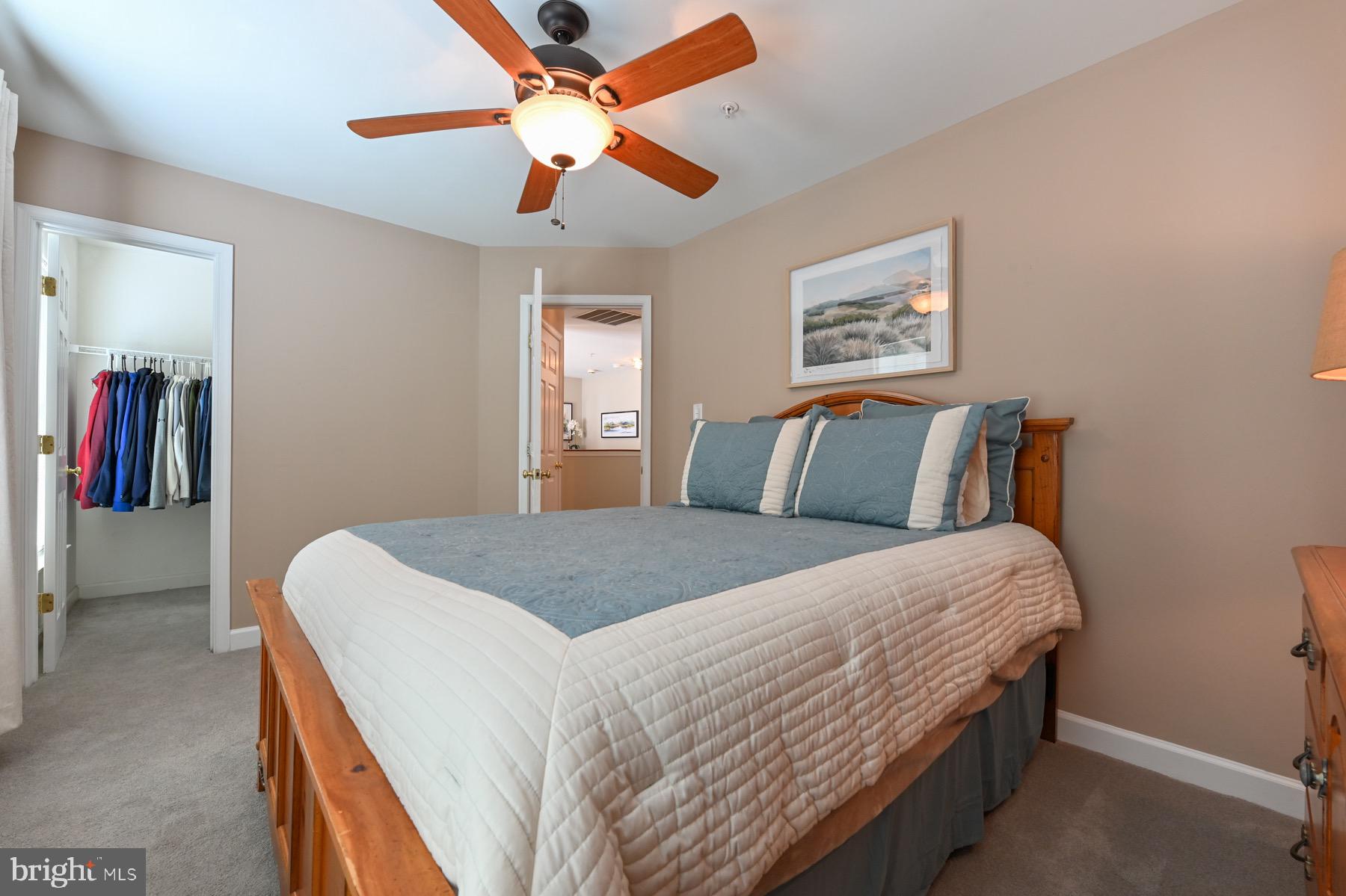 11206 Poplar Grove Court Laurel, MD 20708 - Photo 27 of 67 a bedroom with a bed and a ceiling fan