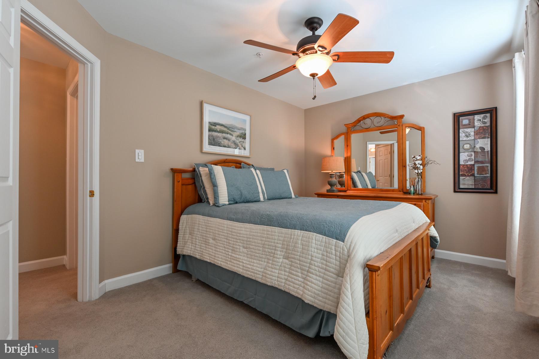 11206 Poplar Grove Court Laurel, MD 20708 - Photo 29 of 67 a bedroom with a bed and a chandelier