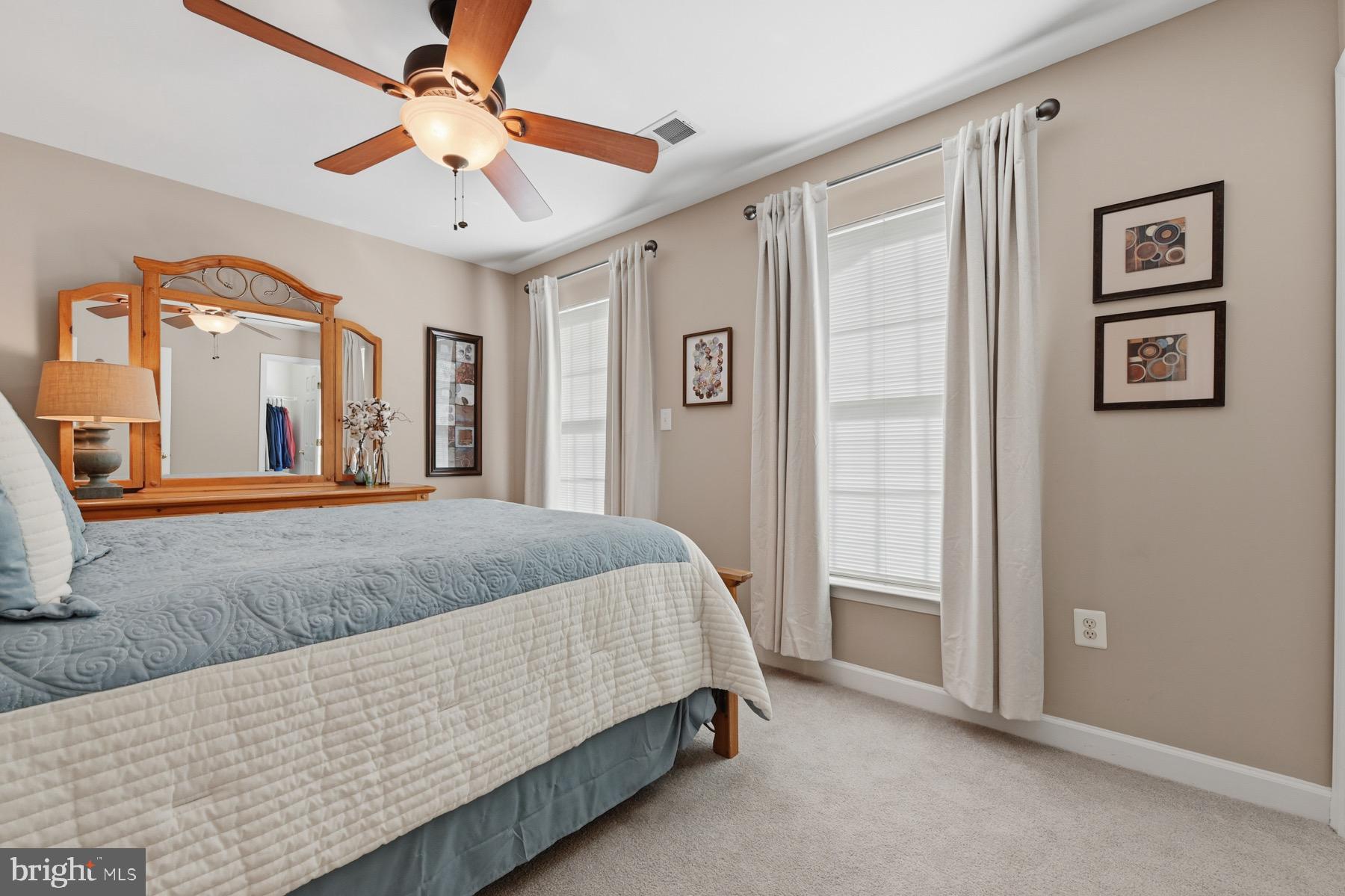 11206 Poplar Grove Court Laurel, MD 20708 - Photo 30 of 67 a bed room with a bed and a ceiling fan