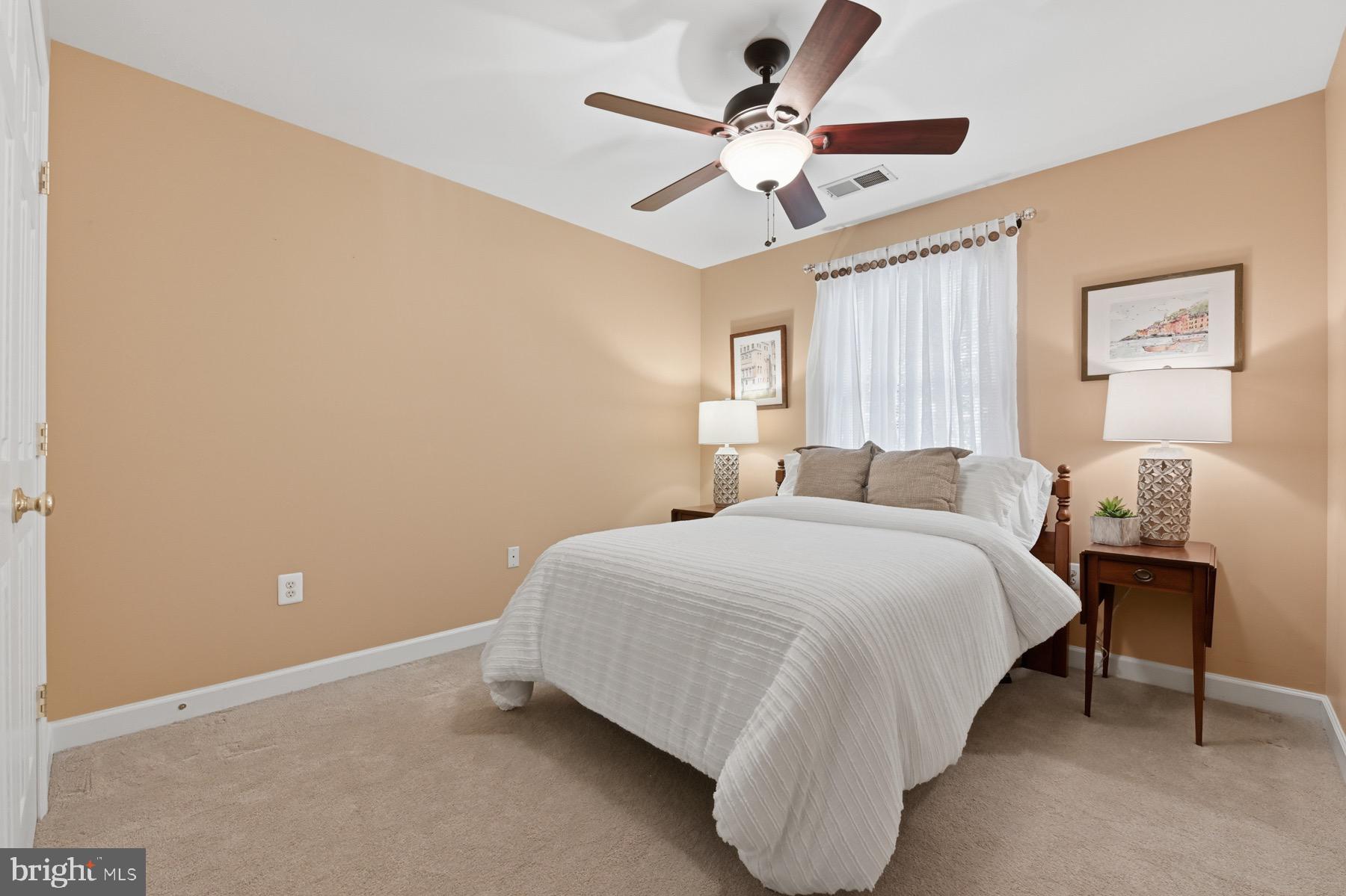 11206 Poplar Grove Court Laurel, MD 20708 - Photo 33 of 67 a bedroom with a bed and a chandelier