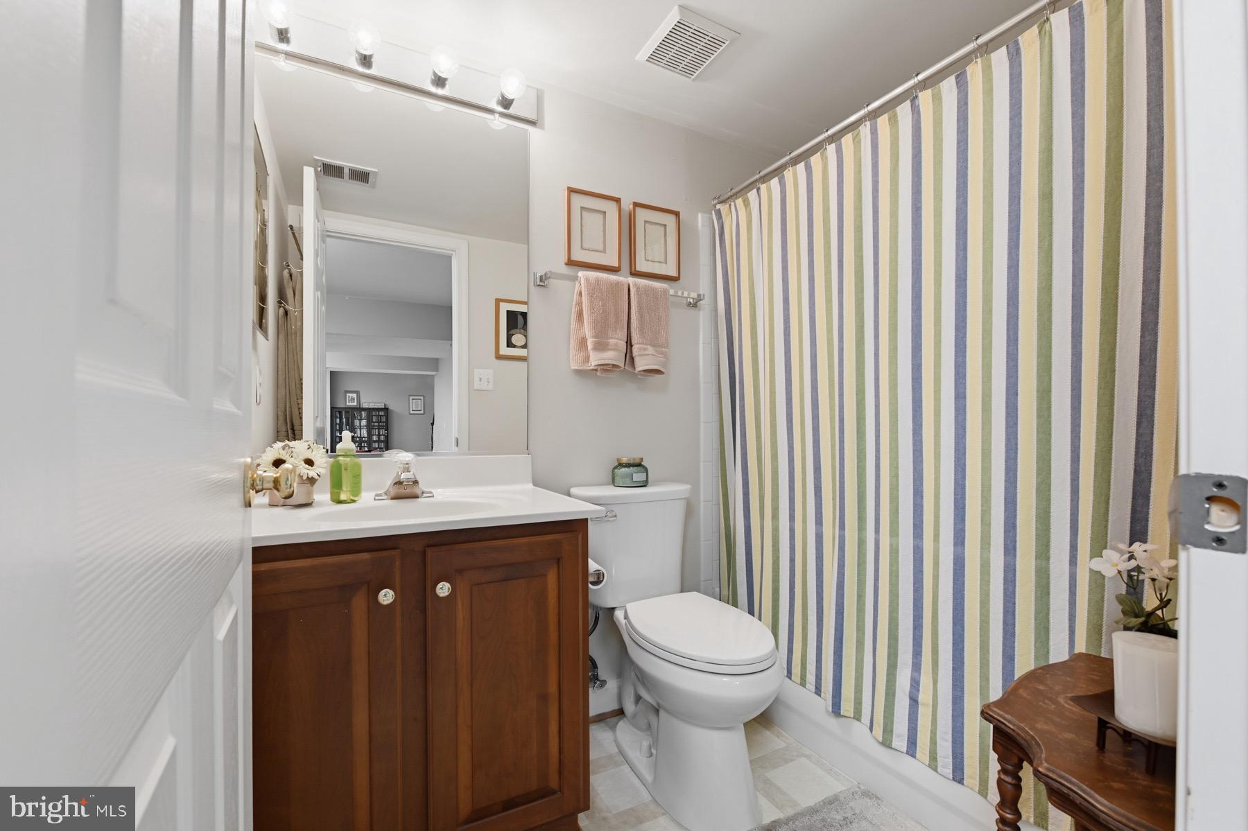 11206 Poplar Grove Court Laurel, MD 20708 - Photo 41 of 67 a view of bathroom with a toilet sink and mirror