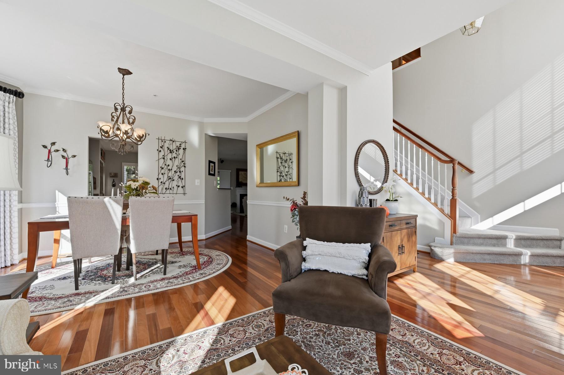 11206 Poplar Grove Court Laurel, MD 20708 - Photo 6 of 67 a living room with furniture a dining table and a chandelier