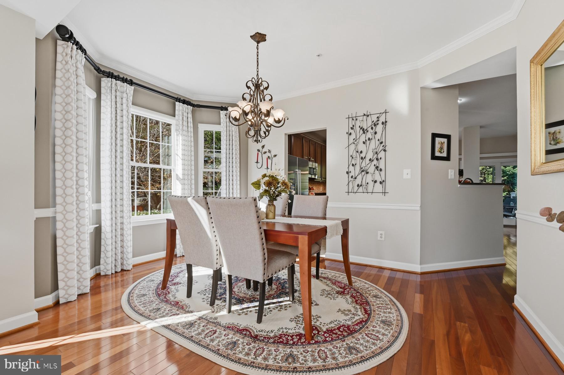 11206 Poplar Grove Court Laurel, MD 20708 - Photo 10 of 67 a view of a dining room with furniture window and wooden floor