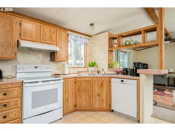 a kitchen with a stove top oven sink and cabinets