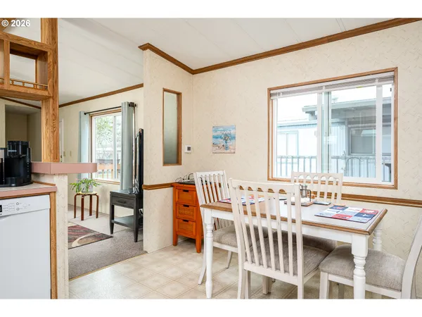 a dining room with furniture and window