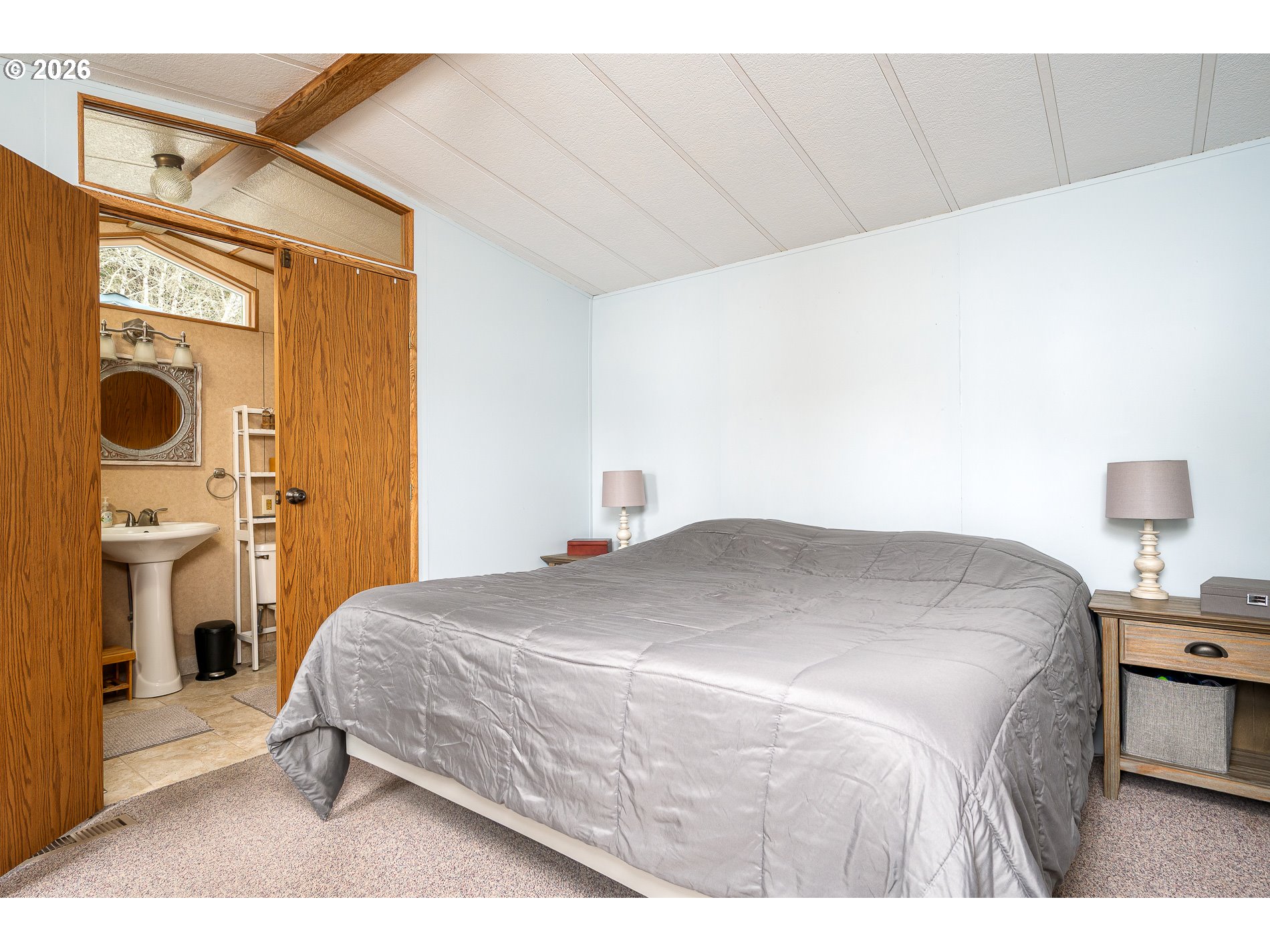648 South Easy Street Rockaway Beach, OR 97136 - Photo 13 of 35 a bedroom with a bed and a tv