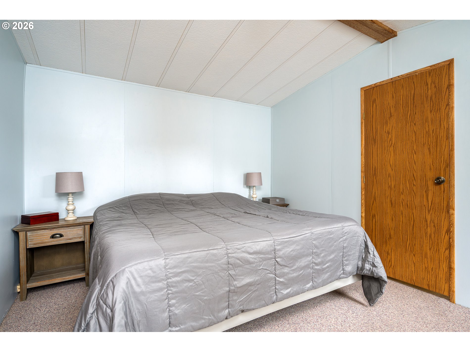 648 South Easy Street Rockaway Beach, OR 97136 - Photo 15 of 35 a bedroom with a bed and a cabinets