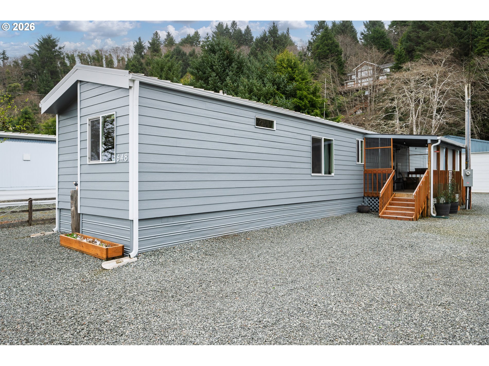 648 South Easy Street Rockaway Beach, OR 97136 - Photo 3 of 35 a view of a backyard with a large tree