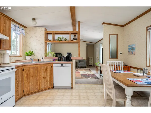 a kitchen with stainless steel appliances kitchen island granite countertop a sink and a refrigerator