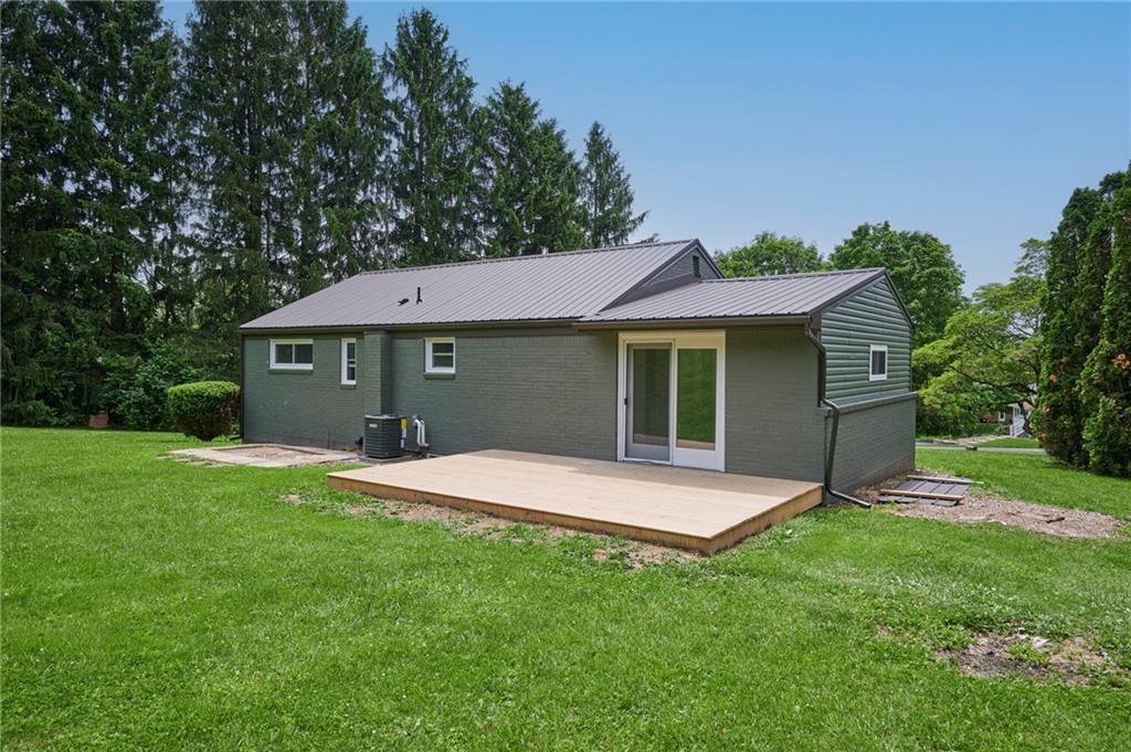 122 Springhouse Drive Butler, PA 16001 - Photo 31 of 42 Back of house with sliding glass door to wooden patio